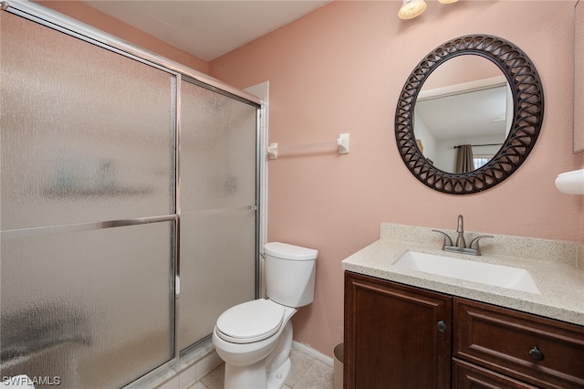 bathroom with toilet, a shower with door, tile floors, and vanity