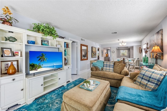 living room featuring a textured ceiling and a chandelier