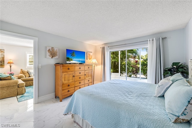 bedroom with a textured ceiling and access to outside