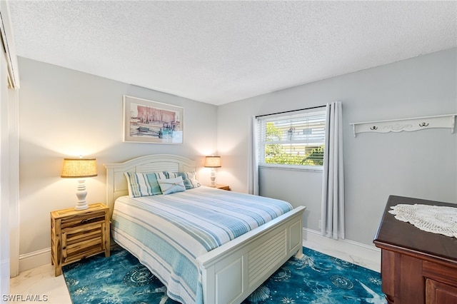 bedroom featuring a textured ceiling