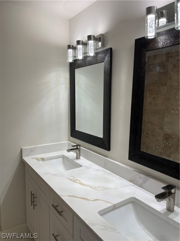 bathroom featuring oversized vanity and dual sinks