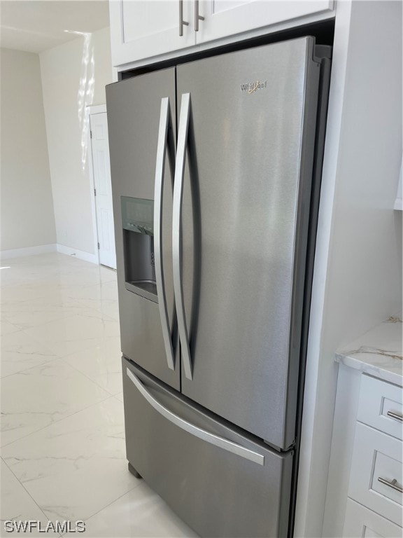 details with vanity, stainless steel refrigerator with ice dispenser, and light tile floors