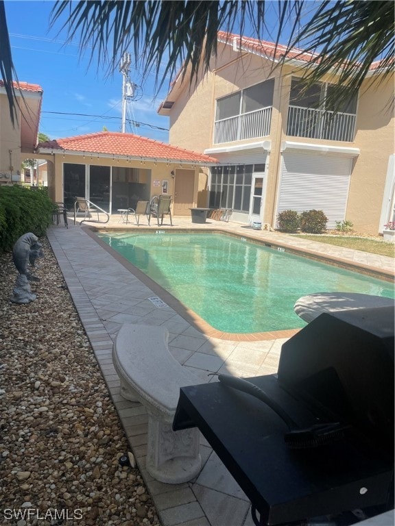 view of swimming pool with a patio area