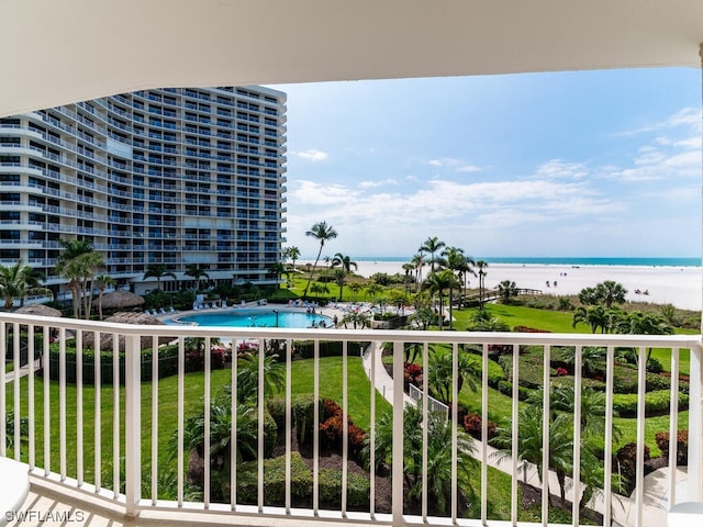 balcony featuring a water view and a community pool