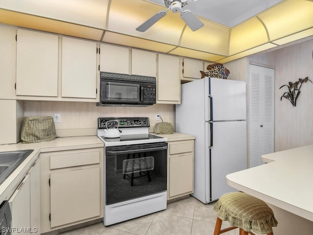 kitchen featuring light tile patterned flooring, white appliances, ceiling fan, and cream cabinets