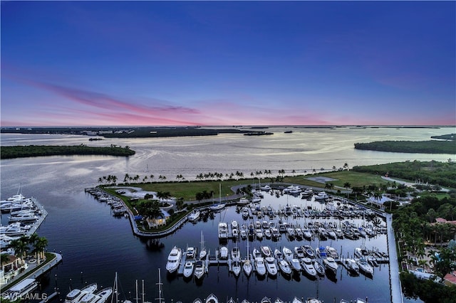 aerial view at dusk featuring a water view