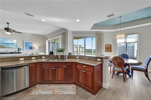 kitchen featuring a wealth of natural light, sink, stainless steel dishwasher, and light hardwood / wood-style floors