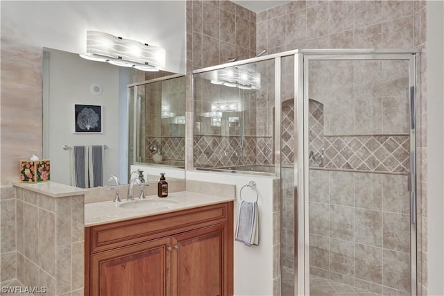 bathroom with a shower with door and vanity