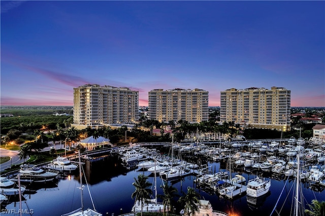 aerial view at dusk featuring a water view