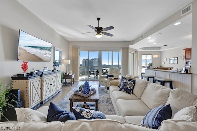 living room featuring light wood-type flooring and ceiling fan