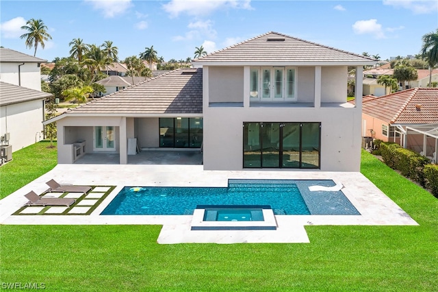 rear view of property with central air condition unit, a yard, and a patio