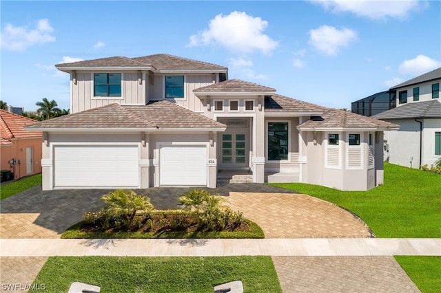 view of front facade featuring a front yard and a garage