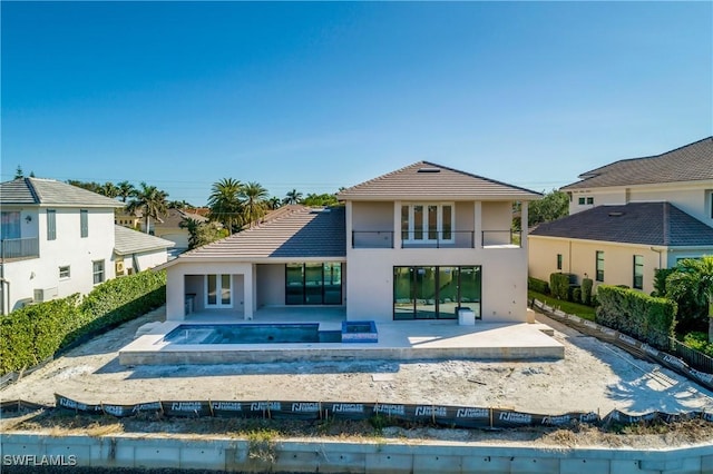 back of house with a patio area and a balcony