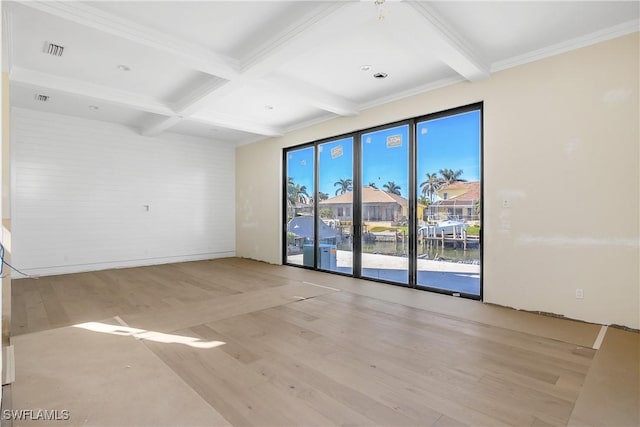 empty room with coffered ceiling, crown molding, beam ceiling, a water view, and light hardwood / wood-style flooring