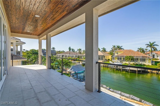 view of patio / terrace featuring a balcony and a water view