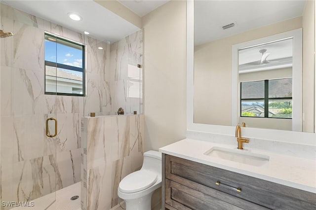 bathroom featuring a marble finish shower, visible vents, toilet, vanity, and recessed lighting