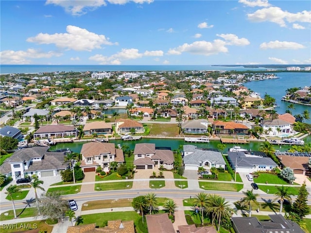 drone / aerial view with a water view and a residential view