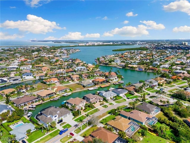 birds eye view of property with a water view and a residential view