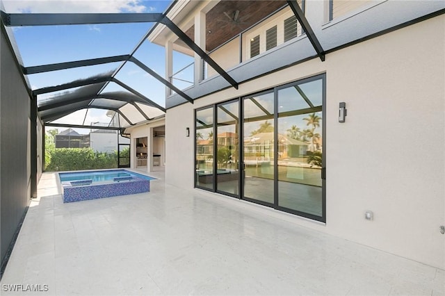 view of pool featuring glass enclosure, a pool with connected hot tub, and a patio