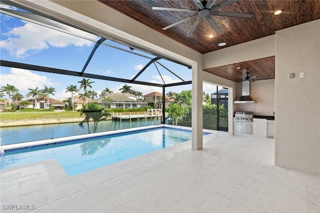 pool featuring a patio, an outdoor kitchen, a lanai, a water view, and a grill