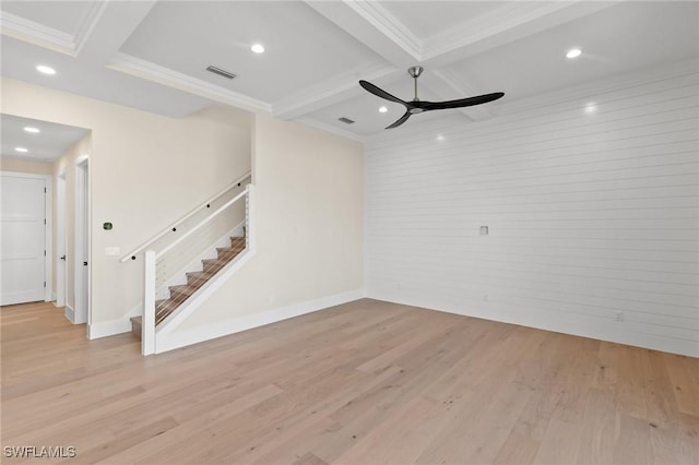 unfurnished living room with baseboards, light wood-style flooring, beamed ceiling, stairs, and crown molding