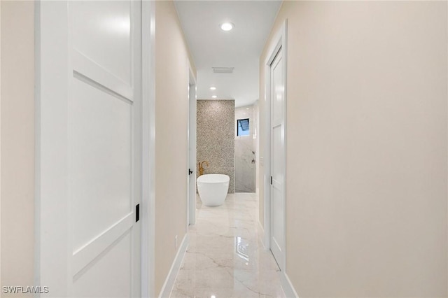 corridor featuring marble finish floor, baseboards, and recessed lighting