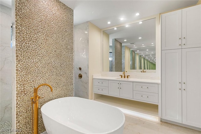 bathroom featuring a freestanding bath, walk in shower, vanity, and recessed lighting