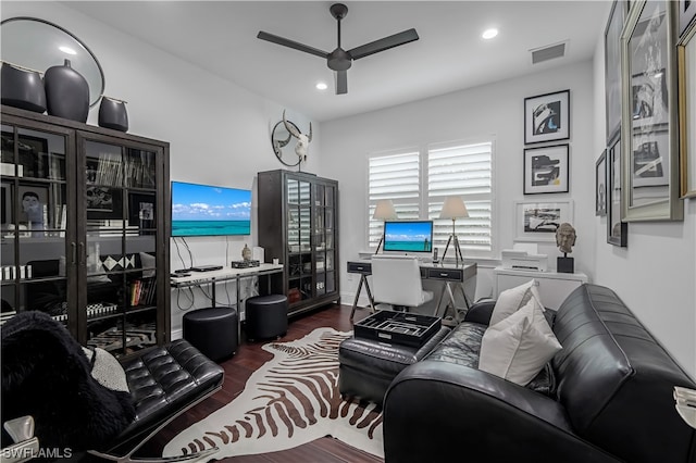 living room with ceiling fan and dark wood-type flooring