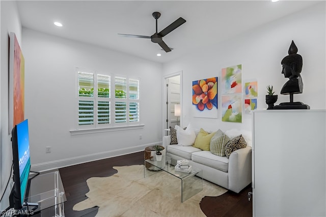 living room featuring dark hardwood / wood-style flooring and ceiling fan