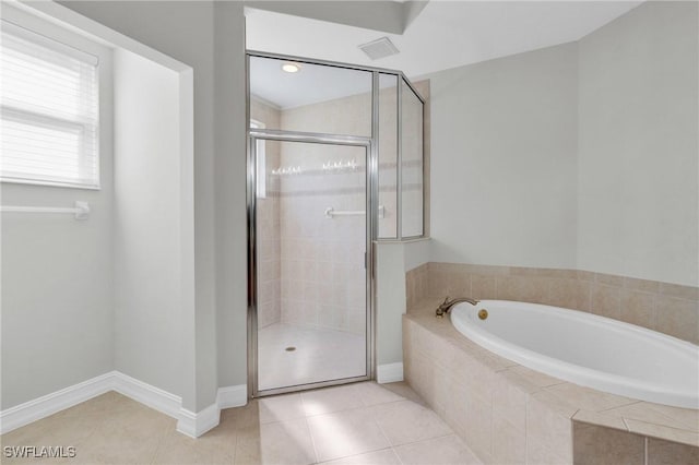 bathroom featuring tile patterned flooring and shower with separate bathtub