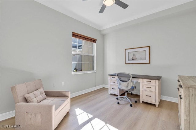 office area with ceiling fan, crown molding, and light wood-type flooring