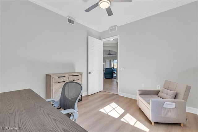 office with crown molding and light hardwood / wood-style floors