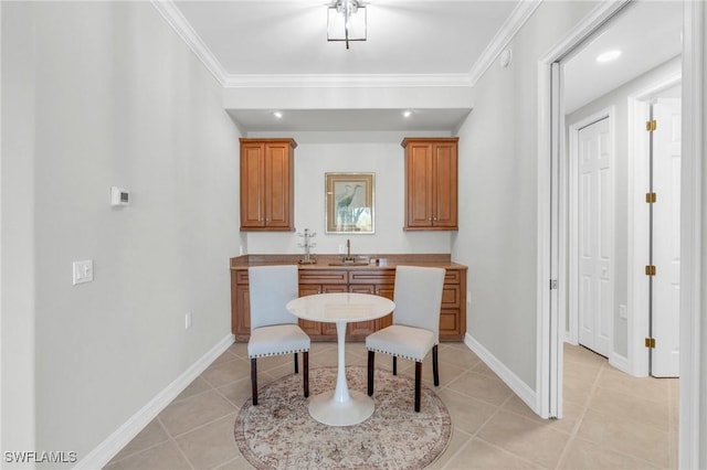 dining area featuring light tile patterned flooring, crown molding, and sink