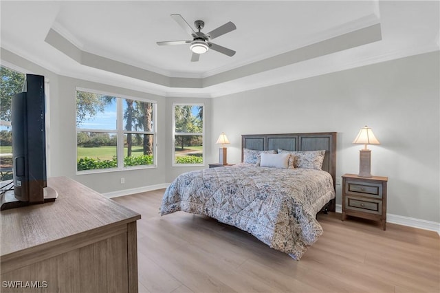 bedroom with multiple windows, ceiling fan, crown molding, and light wood-type flooring