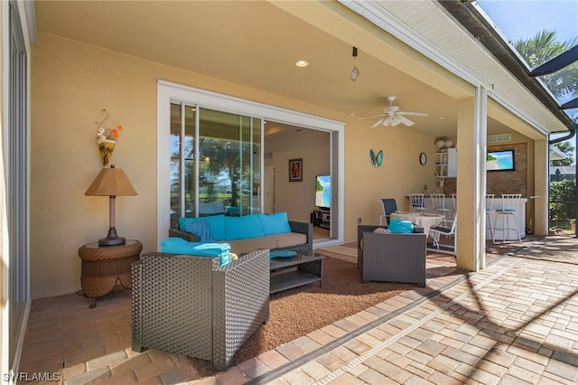 view of terrace with outdoor lounge area and ceiling fan