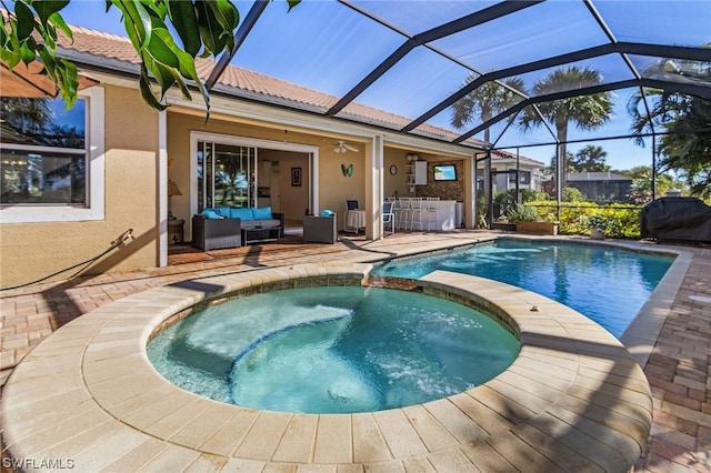 view of pool with an in ground hot tub, outdoor lounge area, a lanai, and a patio