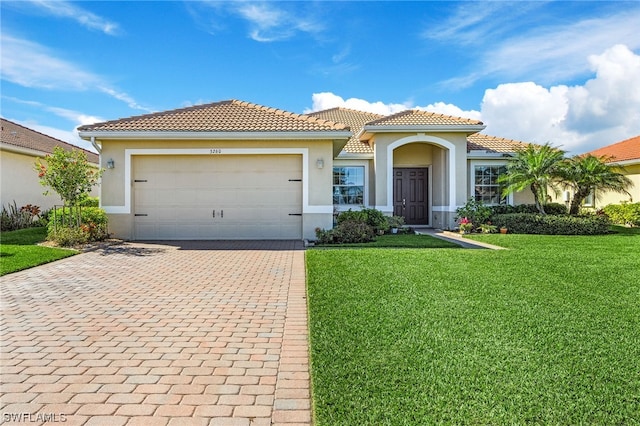 mediterranean / spanish-style home featuring a front lawn and a garage