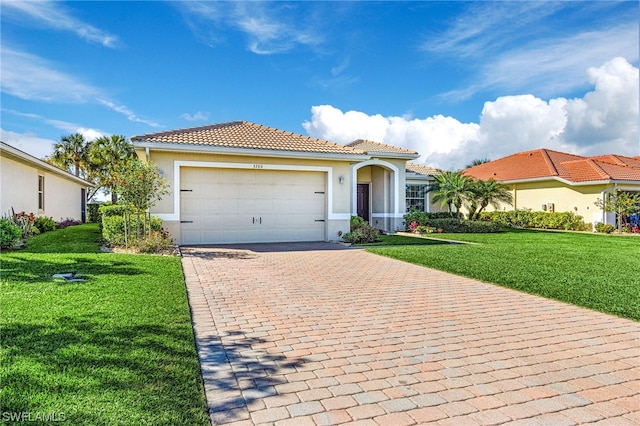 mediterranean / spanish-style home with a front yard and a garage