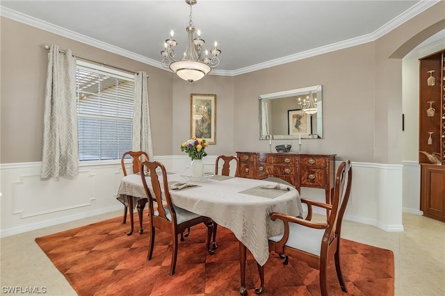 tiled dining room with crown molding and an inviting chandelier