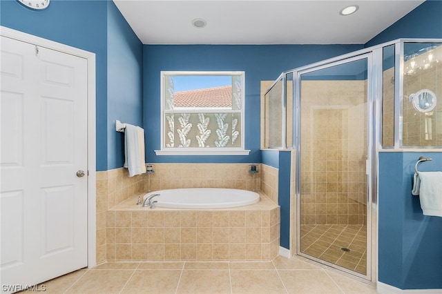 bathroom featuring tile flooring and separate shower and tub