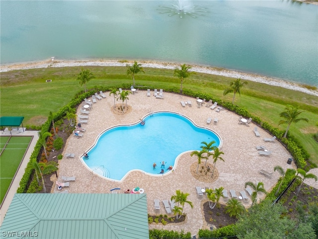 view of swimming pool with a patio area and a water view