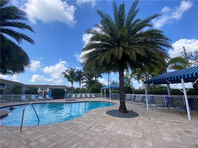 community pool featuring a patio area and fence