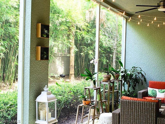 sunroom / solarium with a ceiling fan