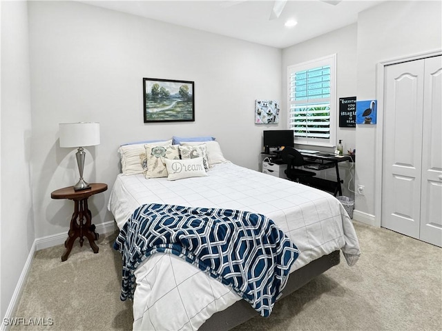 bedroom with carpet floors, a closet, ceiling fan, and baseboards