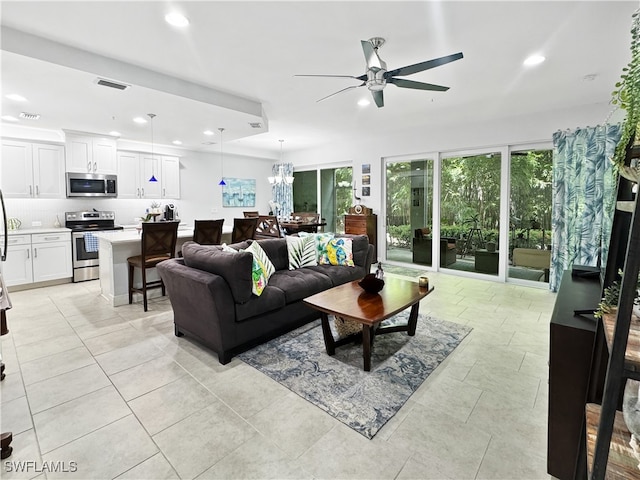 living room with ceiling fan and light tile patterned floors