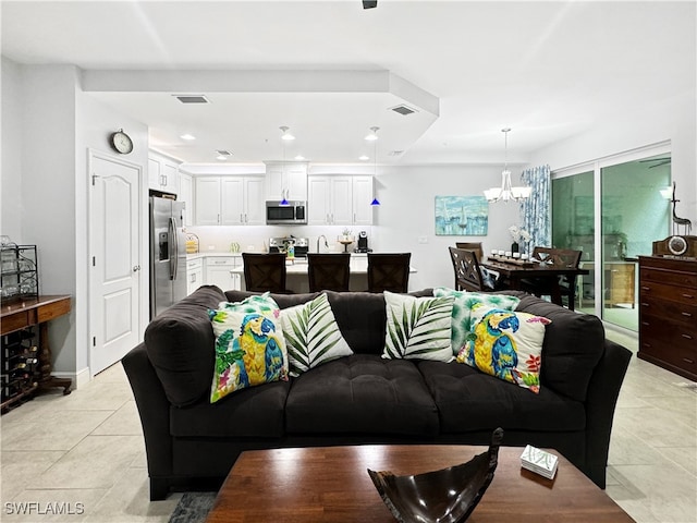 tiled living room featuring a chandelier