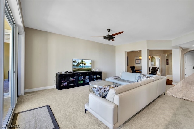 carpeted living room featuring a wealth of natural light and ceiling fan