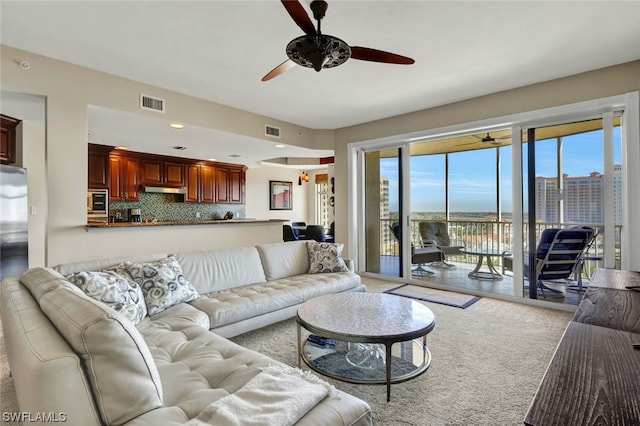 living room featuring light carpet and ceiling fan