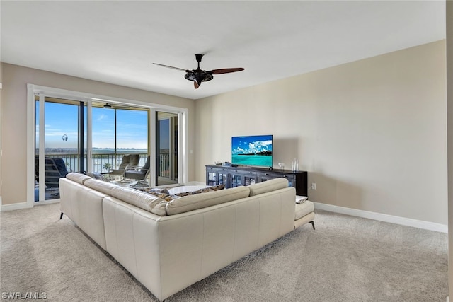 living room featuring light carpet and ceiling fan