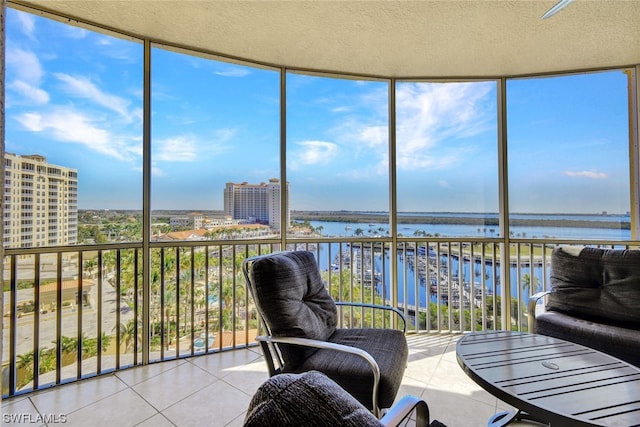 sunroom / solarium featuring a water view